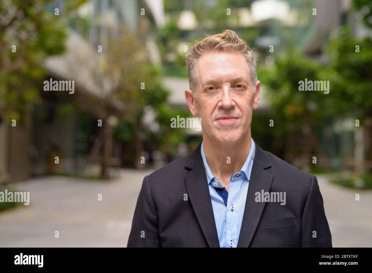 Mature businessman wearing suit with nature in the city Stock Photo - Alamy