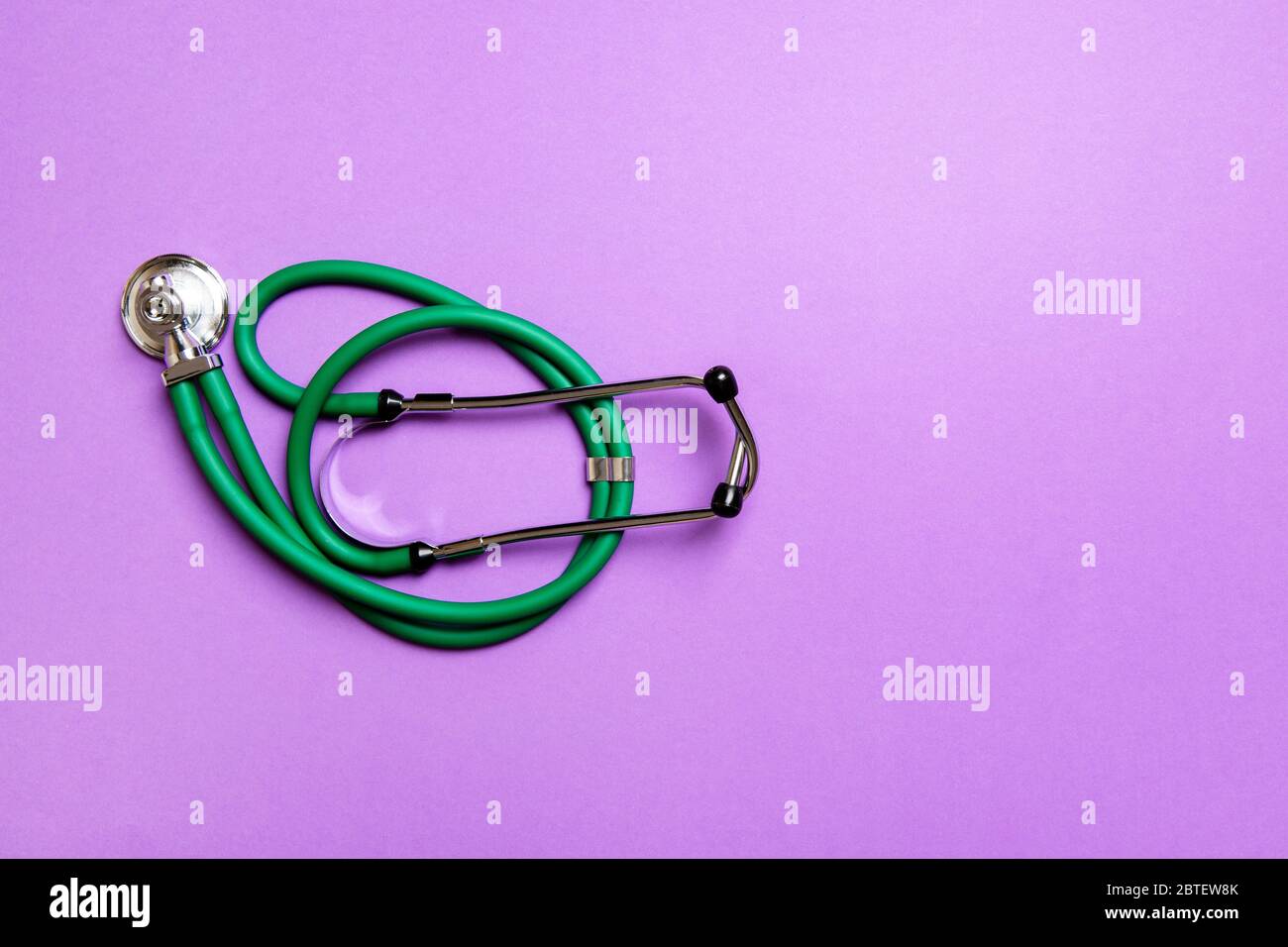 Top view of green medical stethoscope on colorful background with copy ...