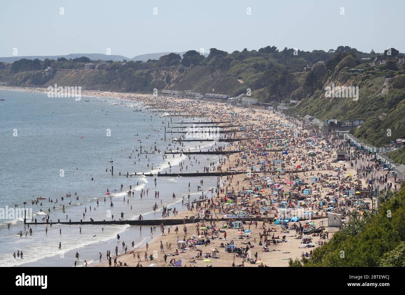 People enjoy the hot weather on Durley and Alum Chine beaches in Dorset, following the introduction of measures to bring the country out of lockdown. Stock Photo