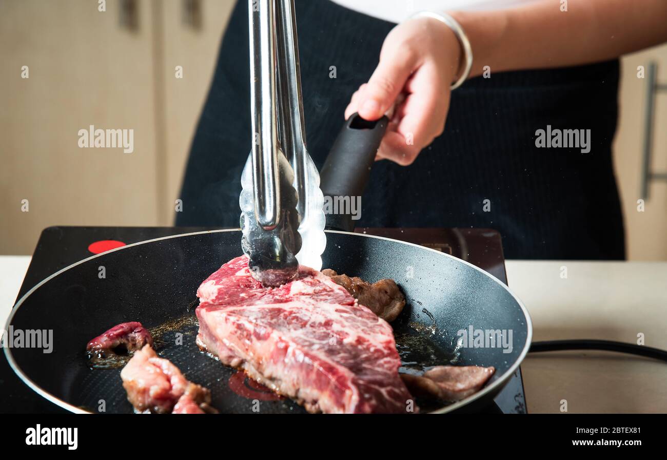 Wagyu Japanese beef steak fying on the pan closeup. Home food preparation Stock Photo