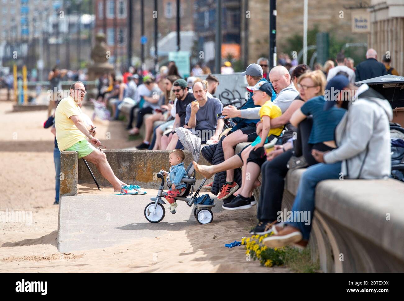 People enjoy the warm weather on Portobello Beach Promenade, Edinburgh
