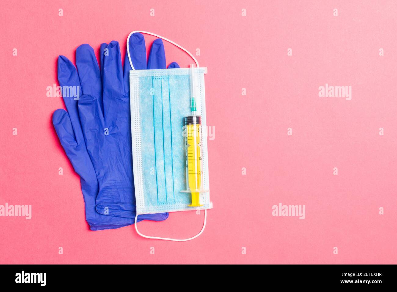 Top view of disposable surgical mask, pair of latex medical gloves and