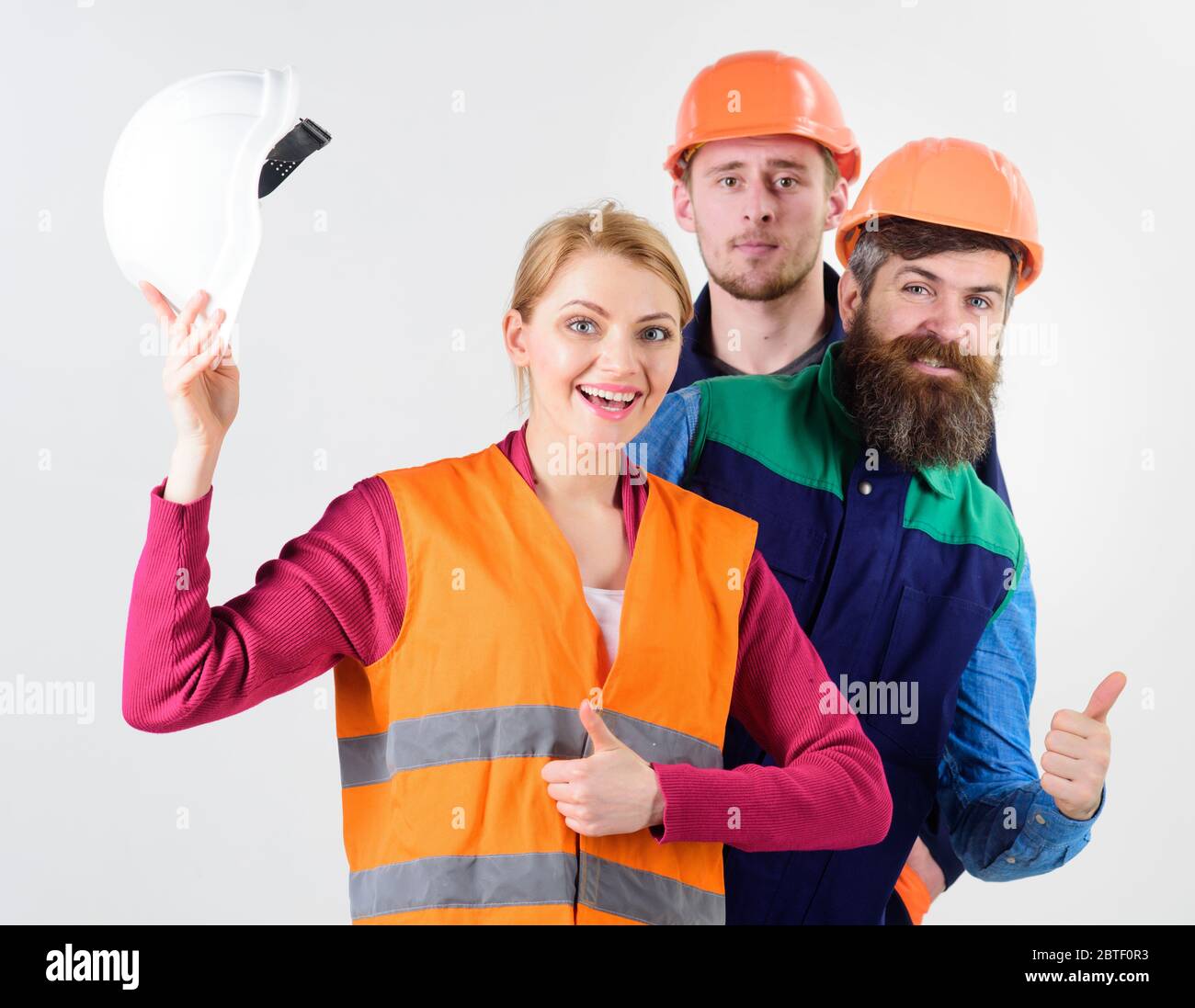 Woman and men holds hard hats. Cheerful collective concept. Team of ...