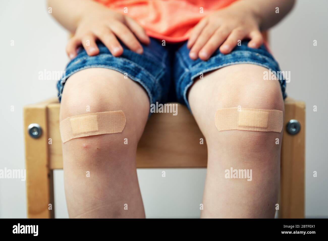 child knees with adhesive bandage strips Stock Photo