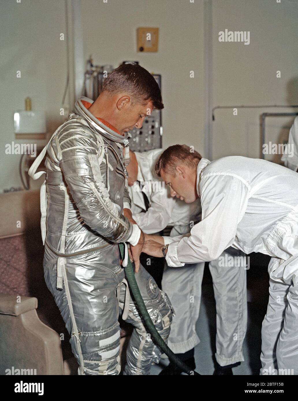 (1962) --- Astronaut Walter M. Schirra Jr., pilot of the Mercury-Atlas 8 (MA-8) Earth-orbital spaceflight, goes through a suiting-up exercise in Hanger 'S' at Cape Canaveral several weeks prior to his scheduled Oct. 3, 1962 flight. Stock Photo