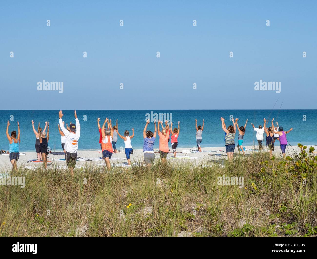 Morning Yoga on Englewood Beach on Manasota Key on the Gulf of Mexico in Englewood FLorida in the United States Stock Photo