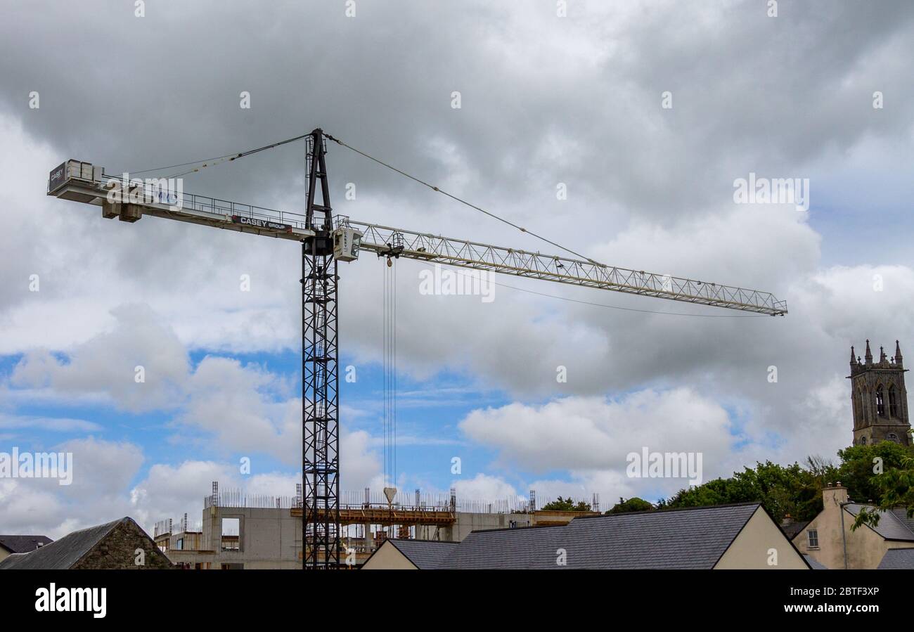 Tower Crane pointing at a church Stock Photo