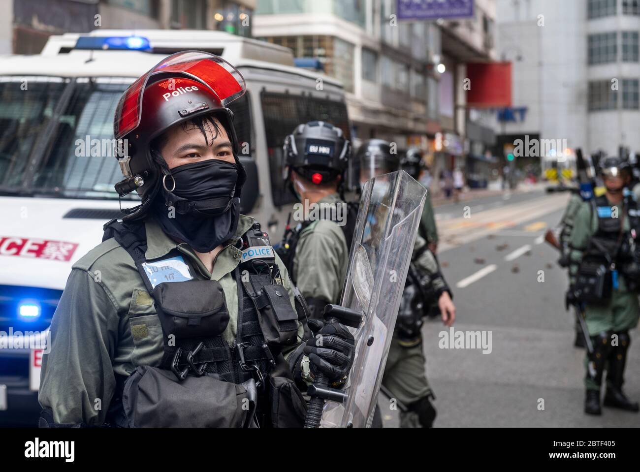Riot police stand on guard in the middle of the Causeway Bay area ...