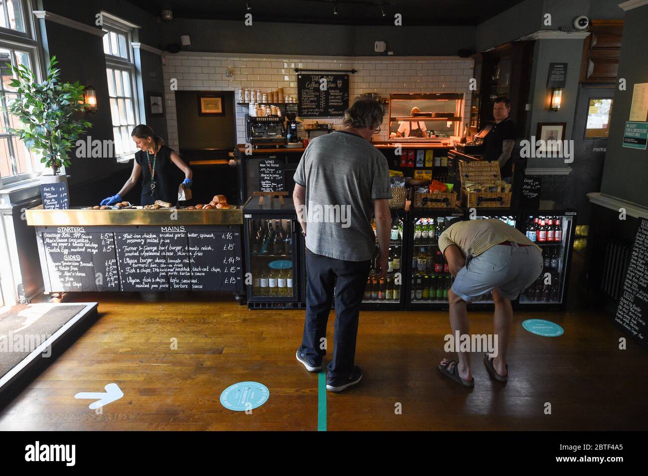 Customers use a one way system at The Crabtree pub in Fulham, London, which offers take away roast dinners after the introduction of measures to bring the country out of lockdown. Stock Photo