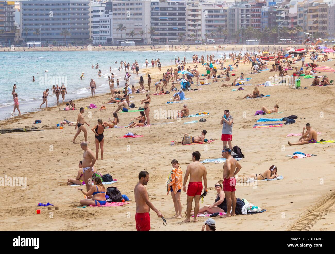 Las Palmas, Gran Canaria, Canary Islands, Spain. 25th May, 2020. Locals  bask on the city beach in Las Palmas on Gran Canaria as The Canary Islands,  and many other regions of Spain,