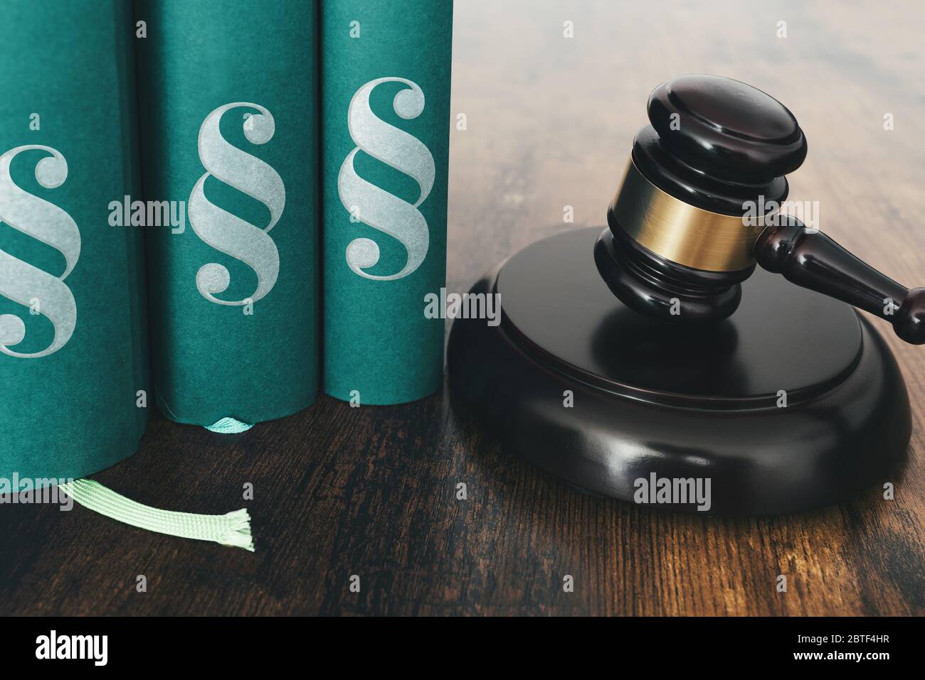 close-up of judges gavel and law books on rustic wooden table Stock Photo