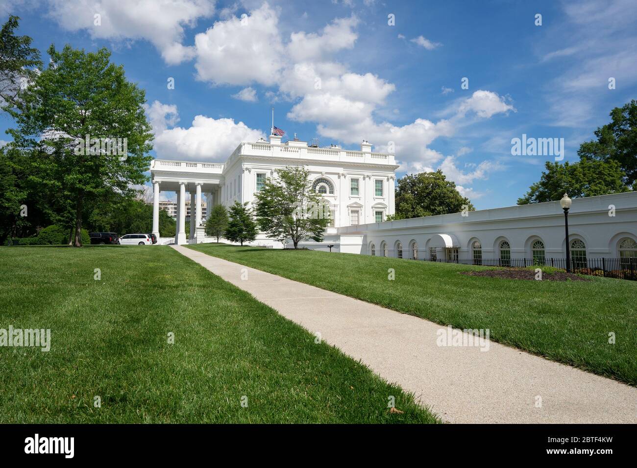 Washington, DC, USA. 23rd May, 2020. The White House is seen in Washington, DC, U.S., on Saturday, May 23, 2020. United States President Donald J. Trump ordered American flags to be flown at half-staff until May 24, 2020 to honor the victims of COVID-19. Credit: Stefani Reynolds/CNP | usage worldwide Credit: dpa/Alamy Live News Stock Photo