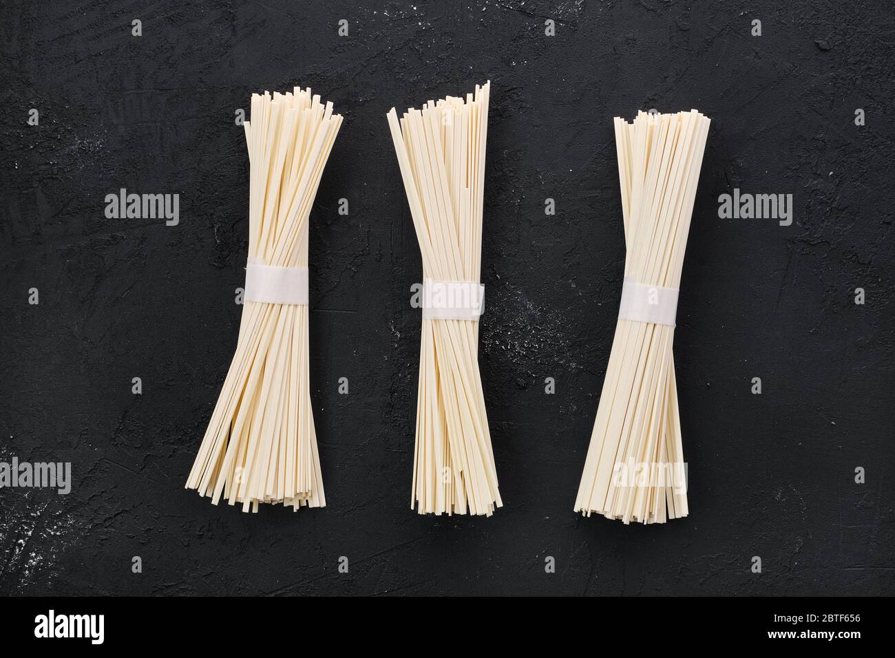 Dry Udon wheat noodles on black background Stock Photo Alamy