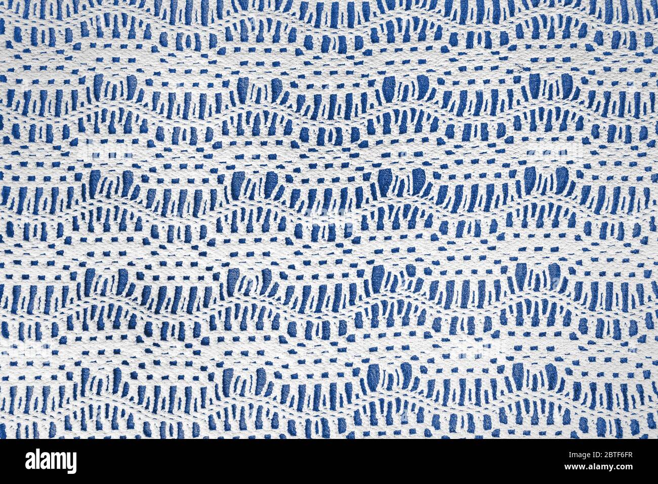 old-fashioned crochet lace pattern on blue background Stock Photo