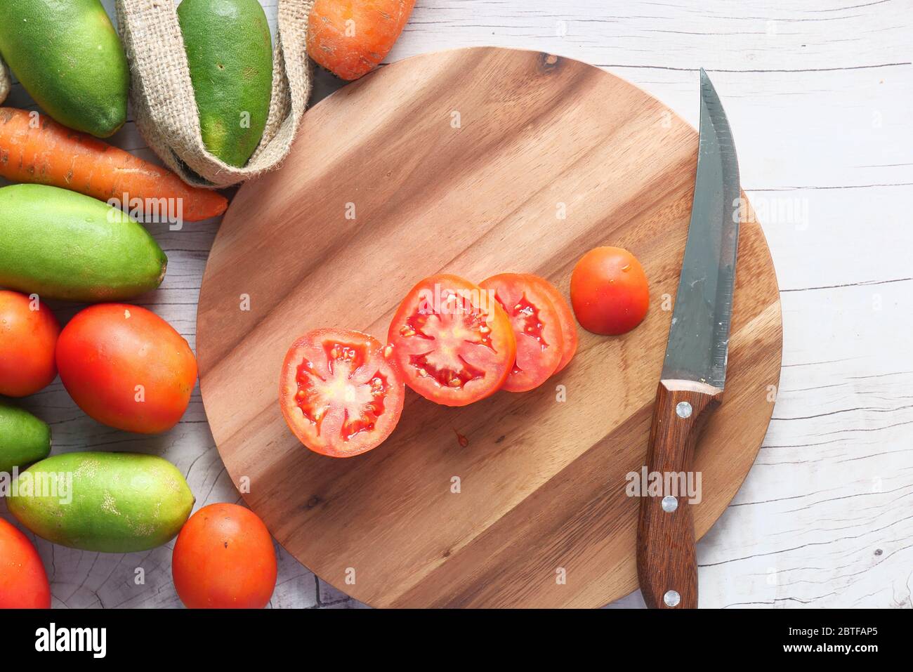 Top view of tomato on chopping board with fresh vegetables Stock Photo ...