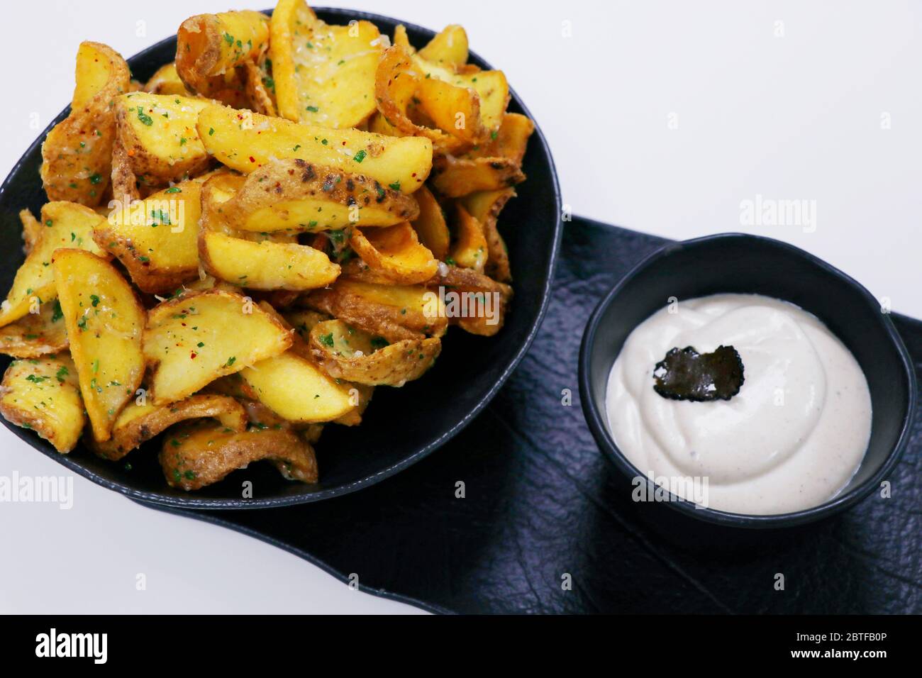 crispy fried potato chips or wedges with truffle cream dip Stock Photo