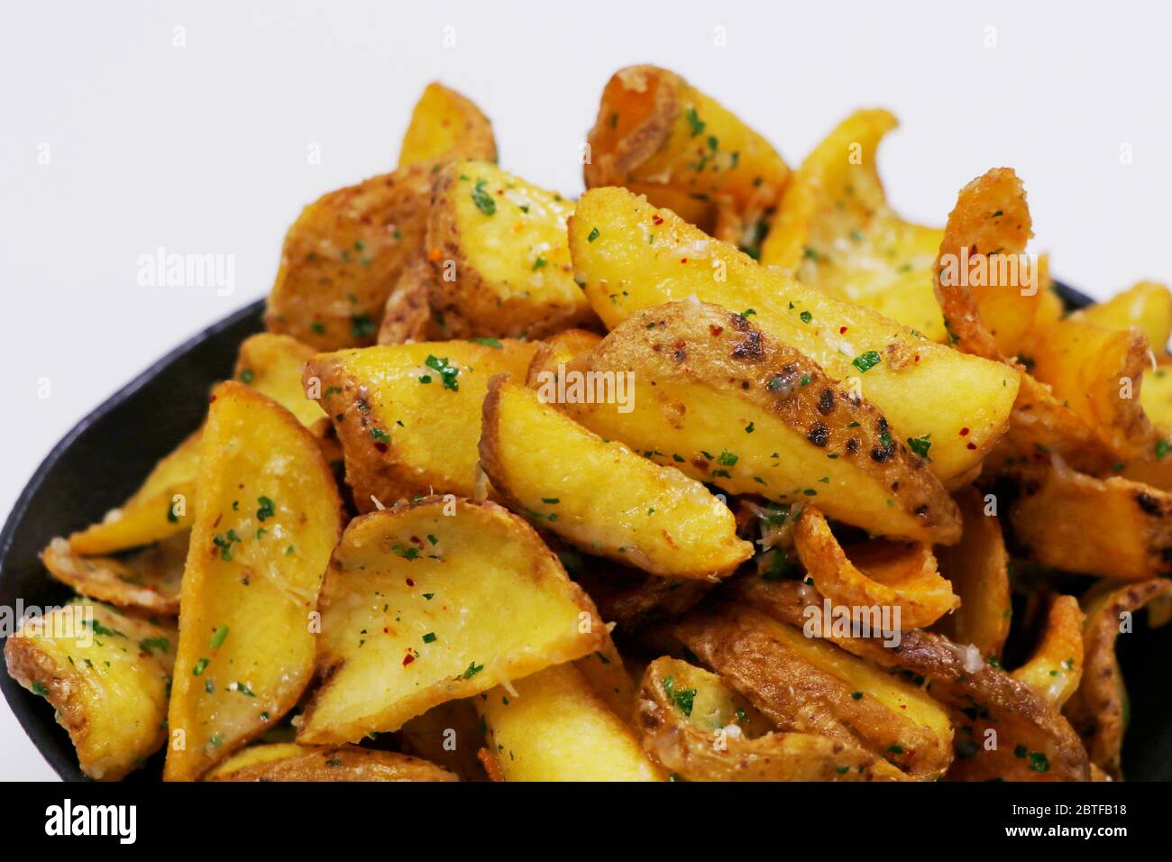 crispy fried truffle parmeesan potato chips or wedges Stock Photo