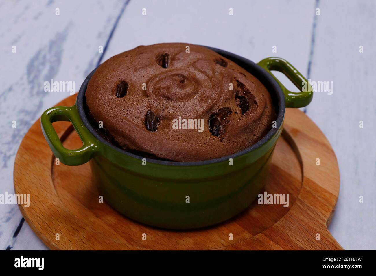 baked chocolate fondant in a metal bowl in rustic way Stock Photo