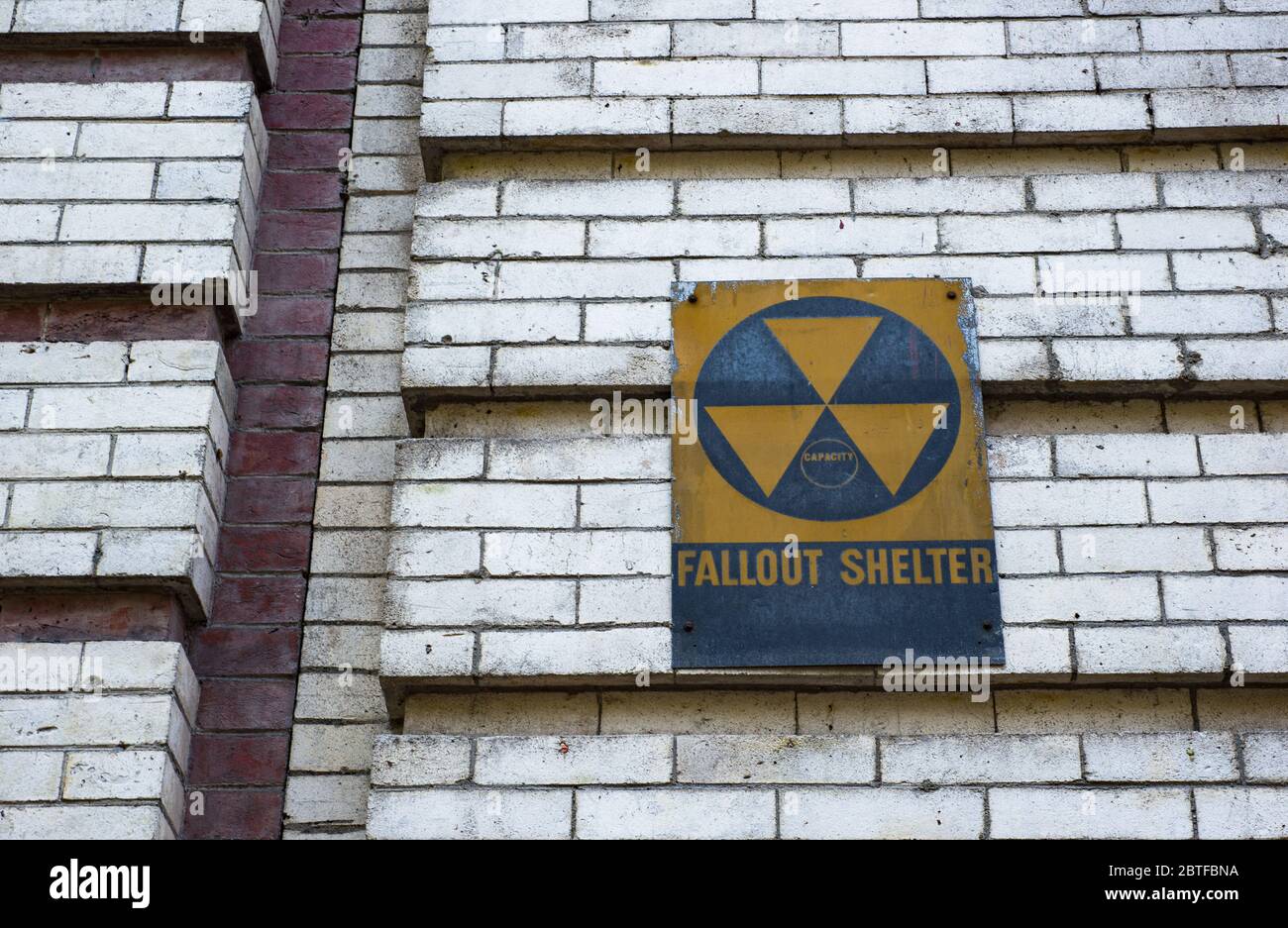 Looking up at vintage nuclear war fallout shelter on an old building Stock Photo