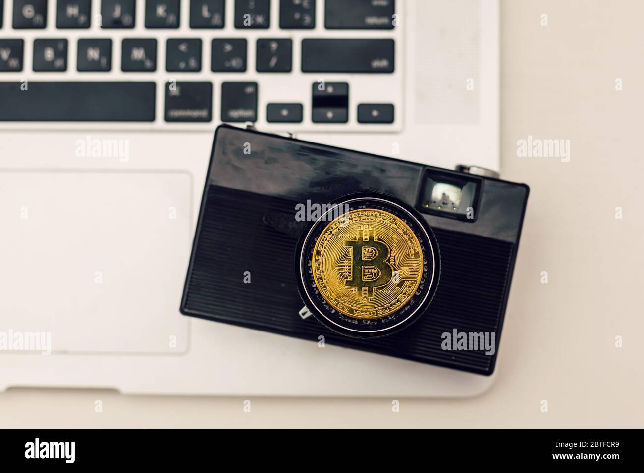 Cryptocurrency physical bitcoin coin in fisheye lenses camera Stock Photo