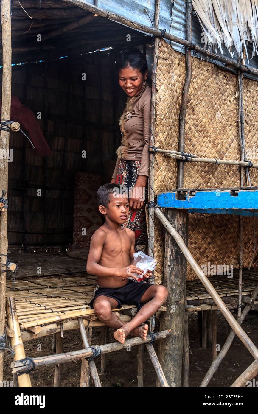 Mother and son at their house in Kompong Pluk (Phluk), a cluster of three villages made of stilt houses within the floodplain of the Tonle Sap River Stock Photo