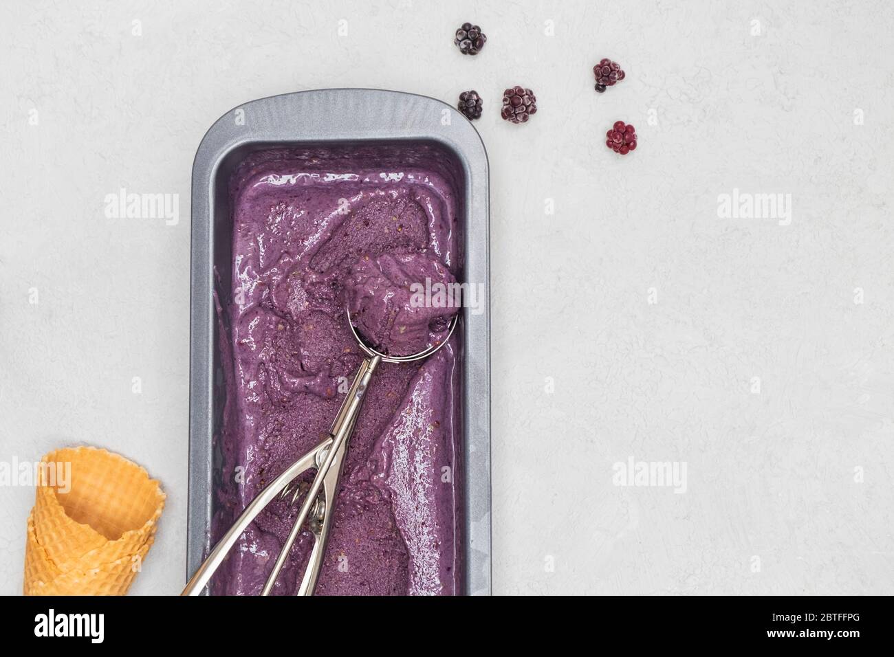 Easy homemade blackberry ice cream with banana and avocado on neutral background with space for text, above view Stock Photo