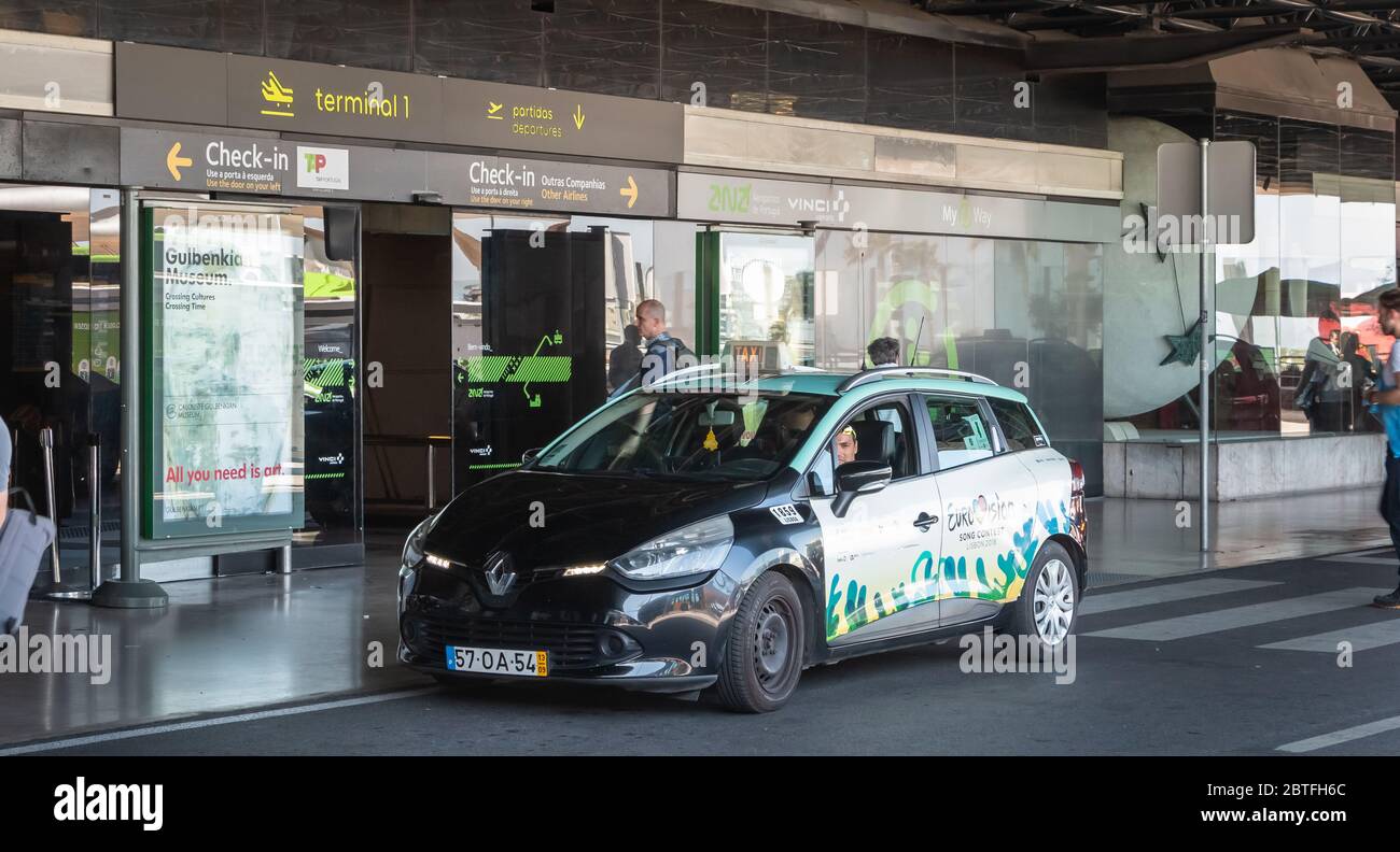 Lisbon, Portugal - May 11, 2018: Taxi dropping off its passenger in front of the check-in and departures entrance of Terminal 1 of Lisbon Internationa Stock Photo