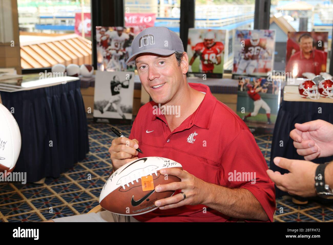 Drew Bledsoe, NFL legend quarterback, autographs footballs at an event for his alma mater, Washington State University. Stock Photo