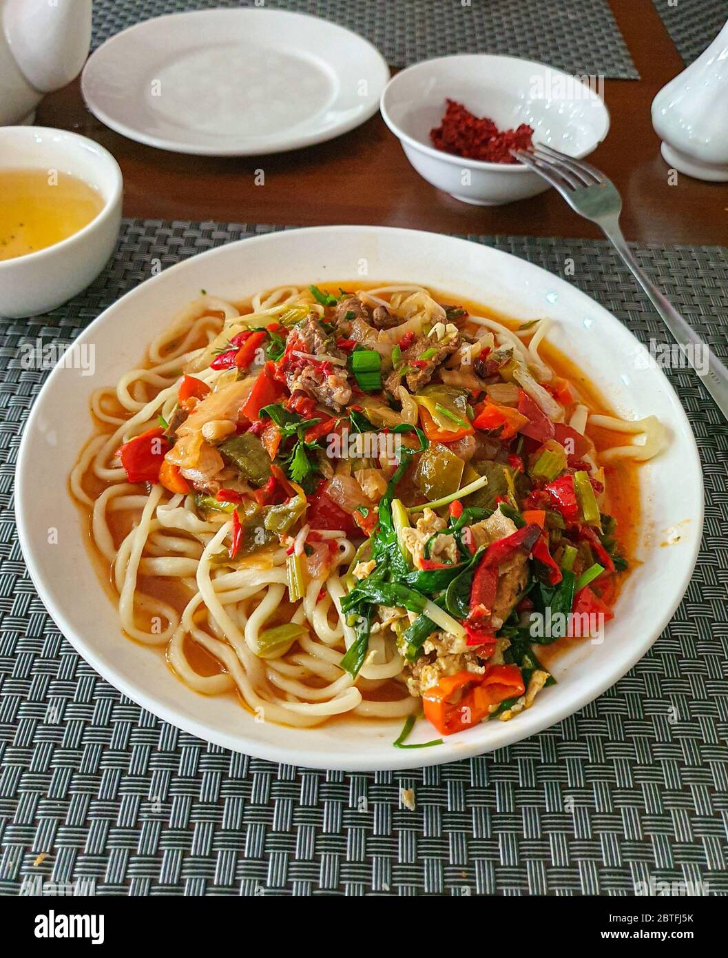 Uzbek traditional national food lagman, soup with noodles, vegetables and meat, mobile photo Stock Photo