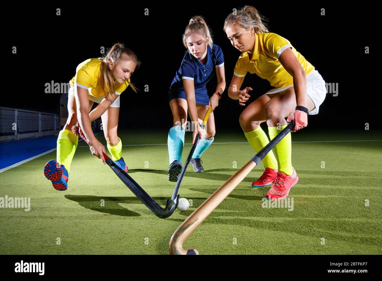 Field hockey female players struggle for the ball. Concept image hockey