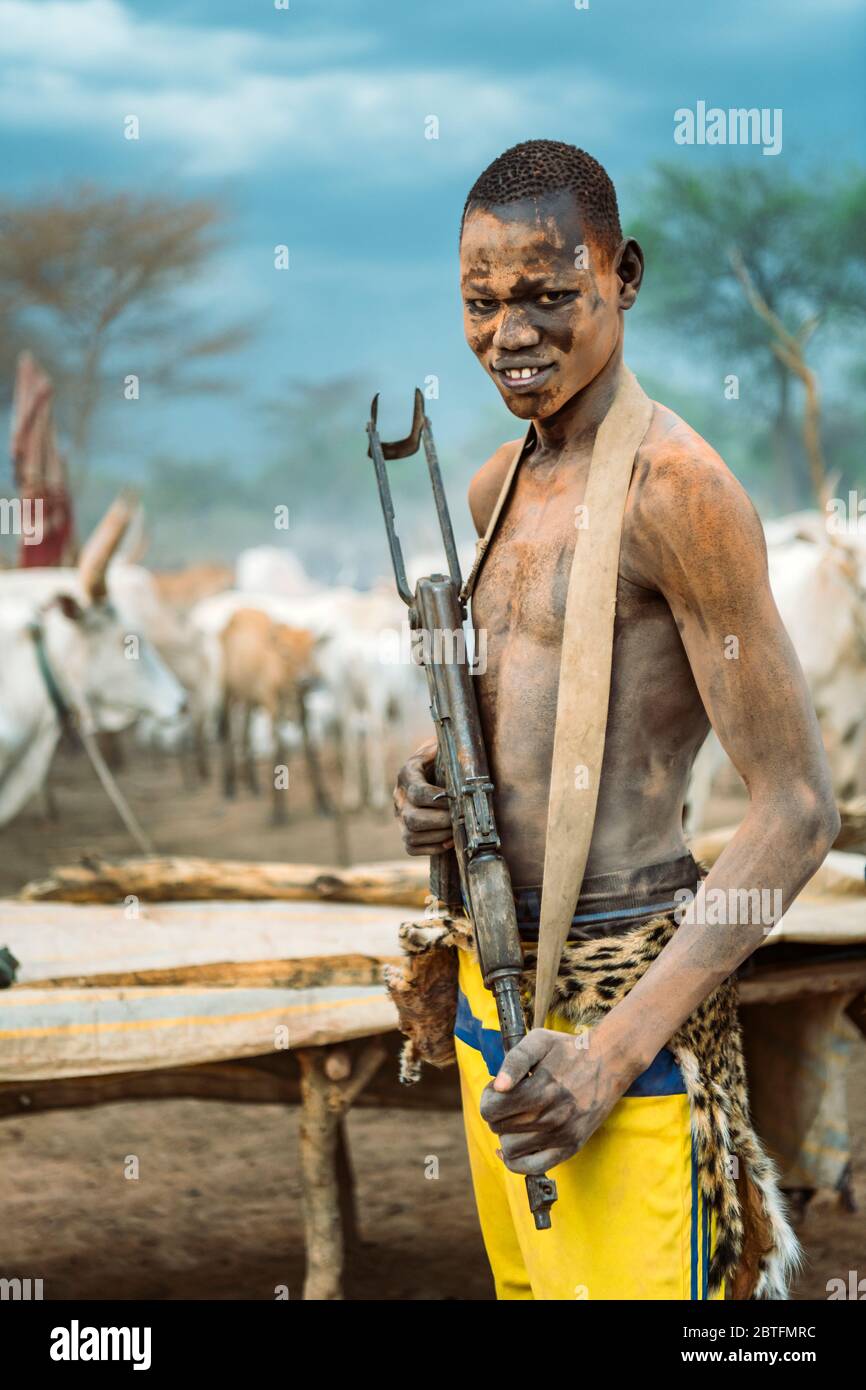 MUNDARI TRIBE, SOUTH SUDAN MARCH 11, 2020 Young man with firearm smiling and looking at
