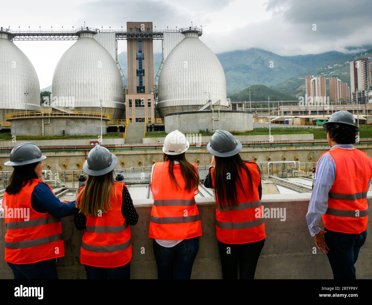 Bello, Colombia, December 17 2019: Group of engineers on a visit in a waste water treatment plant in Bello, Colombia with egg shaped digesters on the Stock Photo