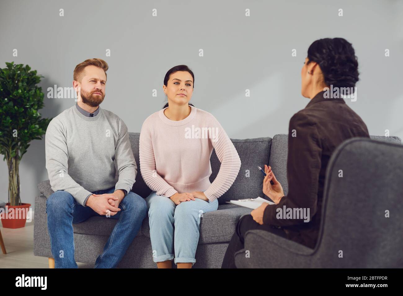 Family psychologist. Female psychologist at a psychotherapy session with family in the office. Stock Photo