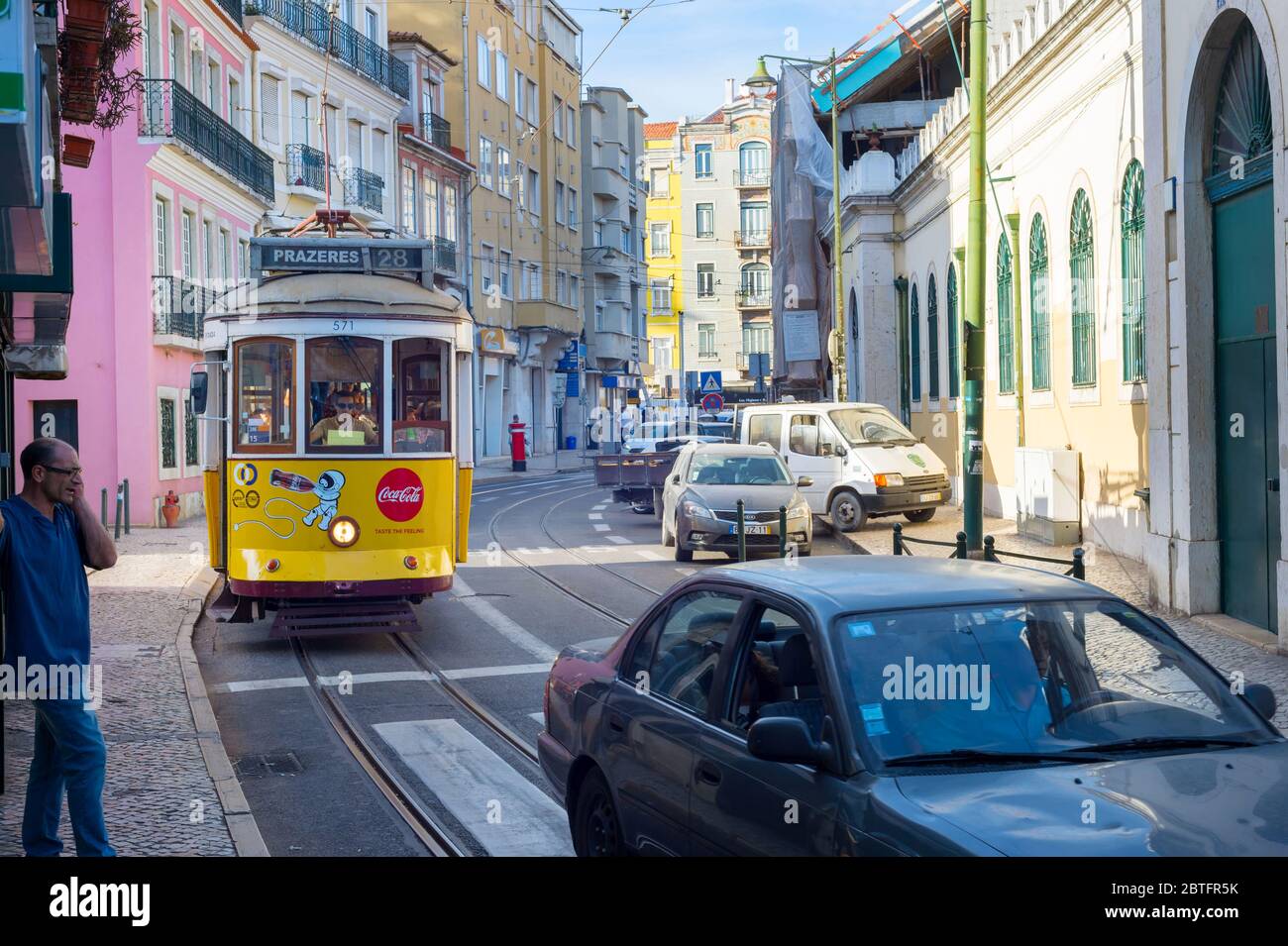 LISBON, PORTUGAL - SEPT 18, 2018: Famous old-fashioned tram 28 on a narrow Lisbon street, Portugal Stock Photo