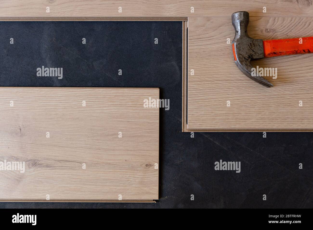 Construction worker installing laminate floor in a new renovated attic. Home improvement concept. Stock Photo