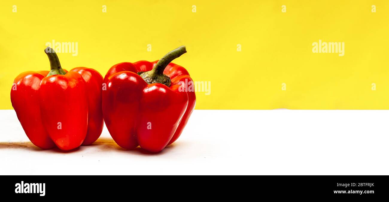 Composition of fresh harvest Bulgarian pepper on a yellow backround. Space for text. Stock Photo