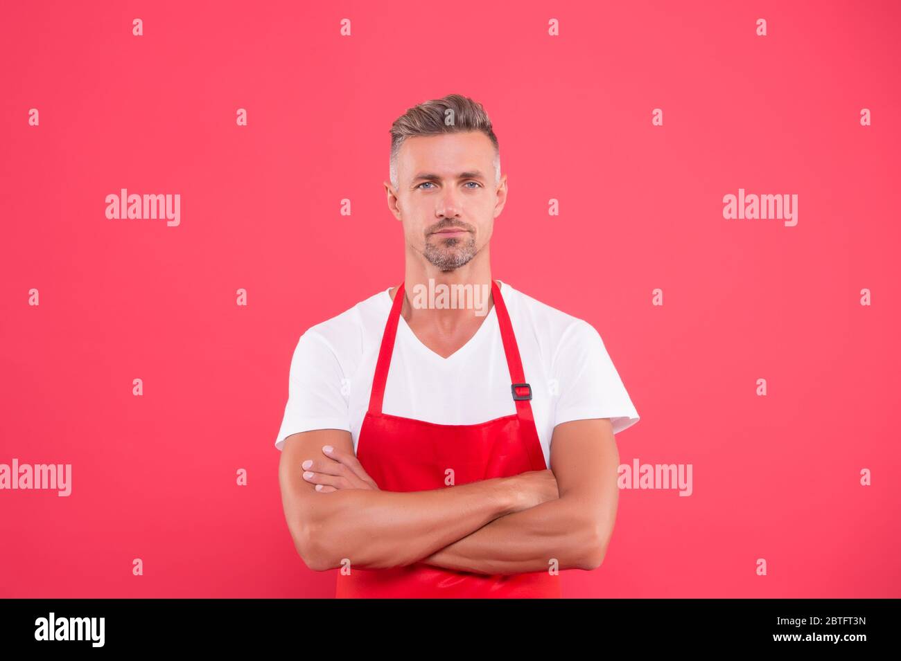 mature man in apron crossed hands. hostess of the restaurant. Fast food