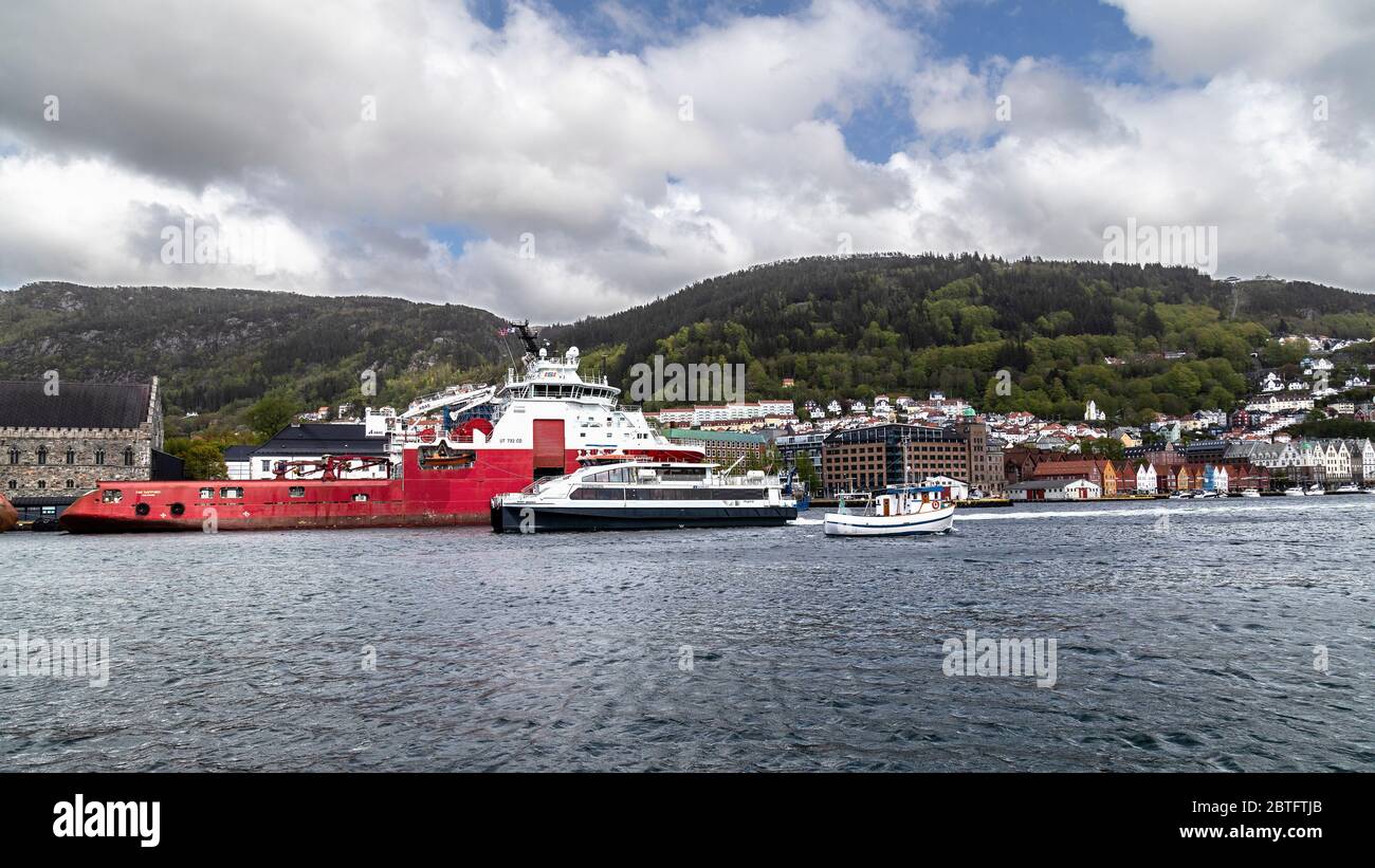 Veteran shrimp trawler Balder (built 1963, rebuilt 1975) and high speed passenger catamaran Ekspressen in front of offshore AHTS anchor handling tug s Stock Photo