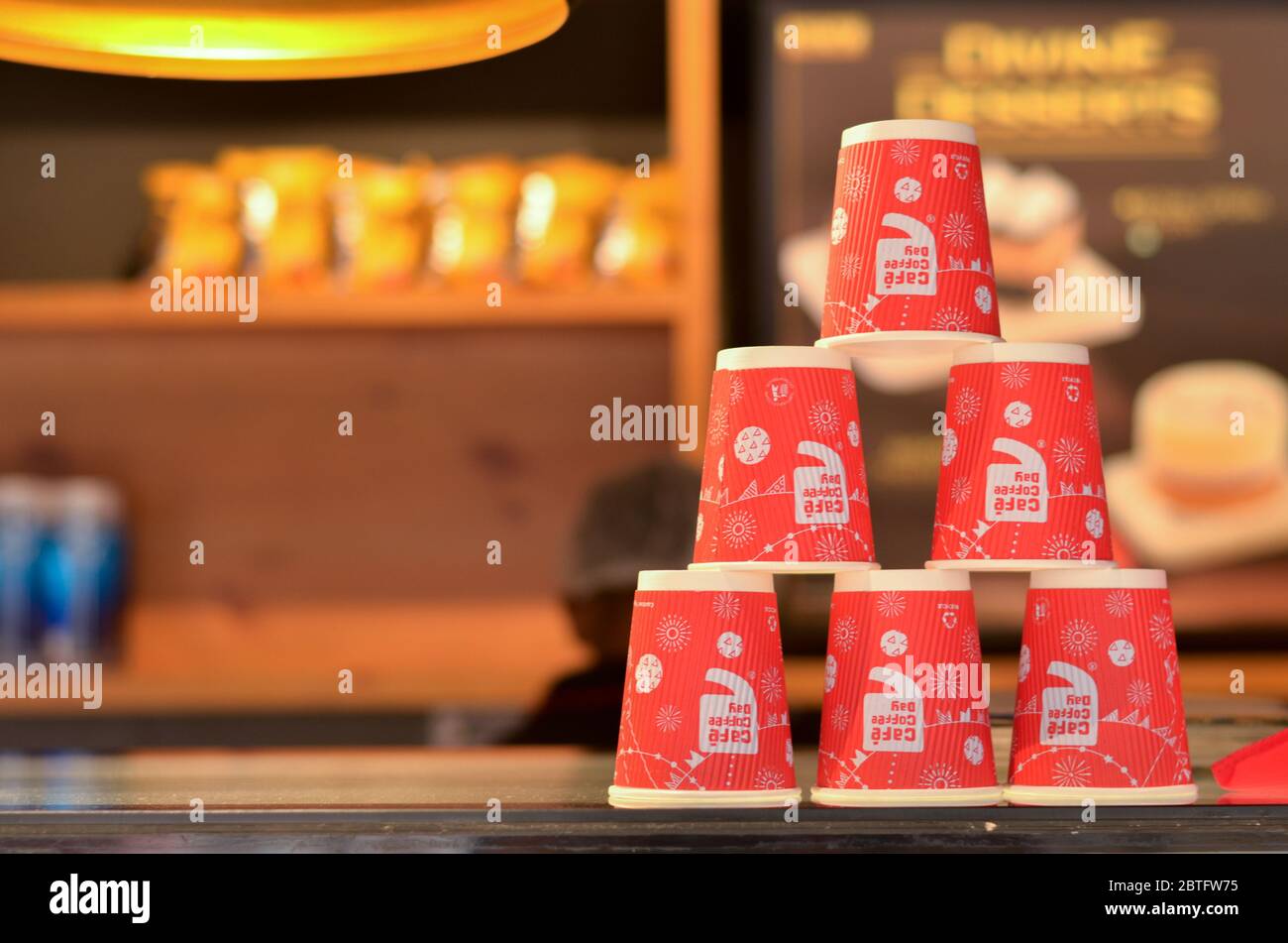 New Delhi, India, 2020. Red disposable cups with CCD (Cafe Coffee Day) logo stacked on top of each other making pyramids on the counter for display Stock Photo