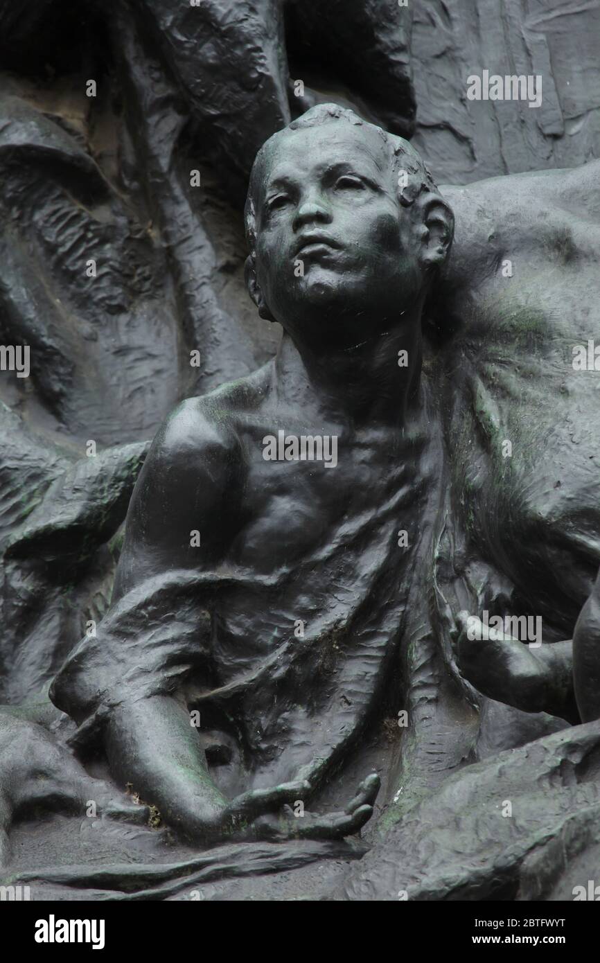 Young boy depicted in the detail of the monument to Jan Hus designed by Czech sculptor Ladislav Šaloun (1915) in Old Town Square (Staroměstské náměstí) in Prague, Czech Republic. Stock Photo