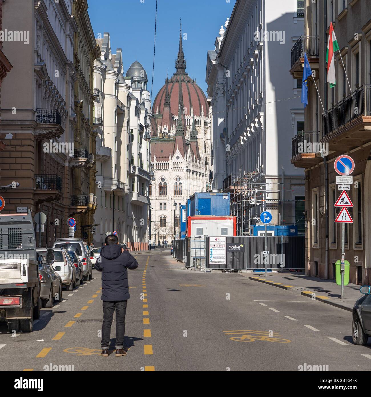 Feb 8, 2020 - Budapest, Hungary: Tourist take photo of Hungarian Parliament on Akademia street Stock Photo