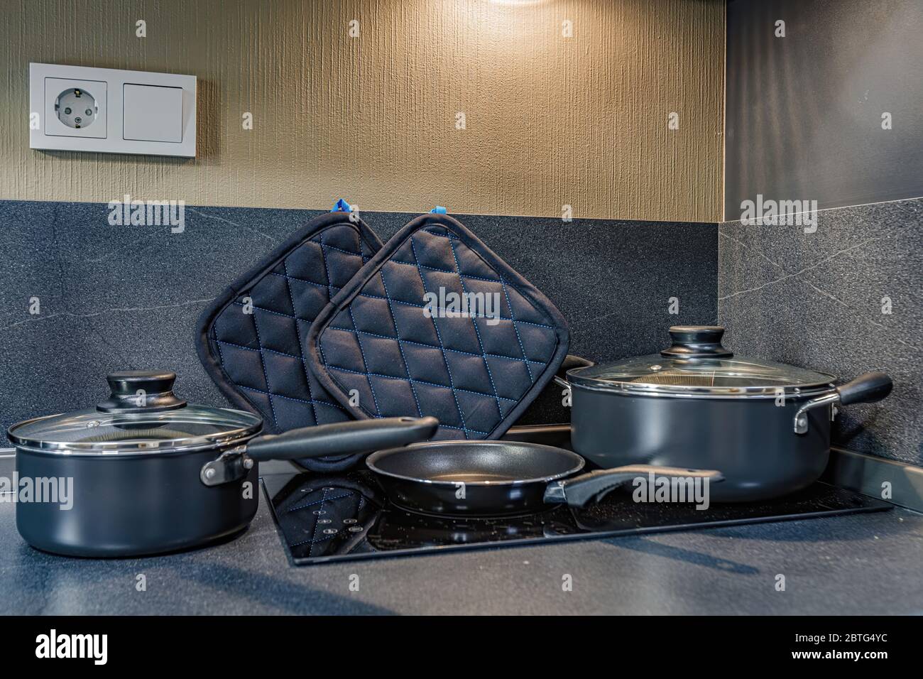 empty pan on stove with stands on table closeup modern kitchenware Stock Photo