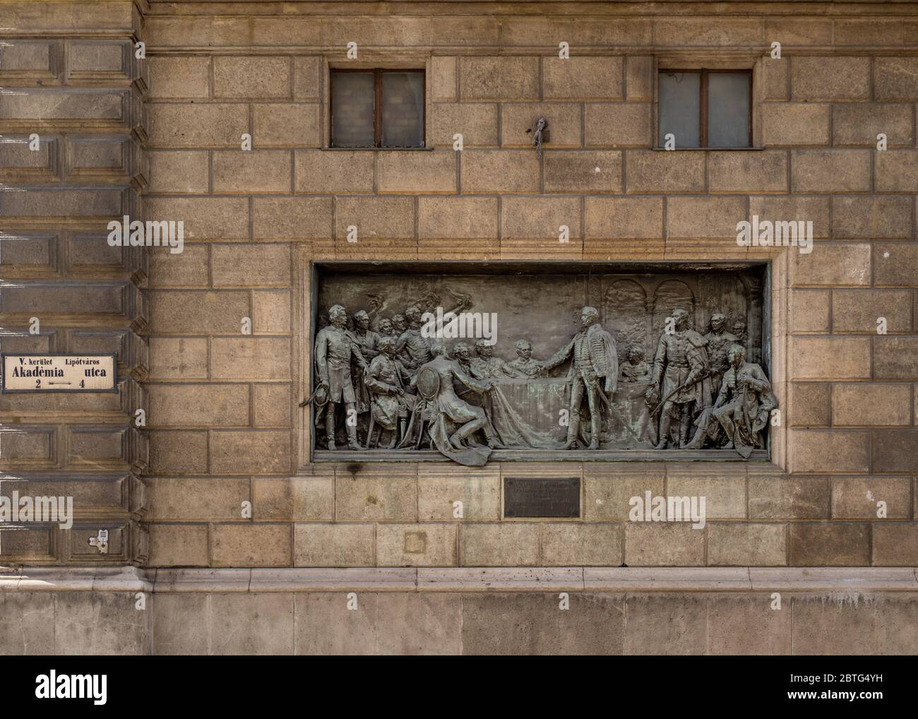 Feb 8, 2020 - Budapest, Hungary: Bronze relif plaque of founding of Hungarian academy of science on Akademia utca street Stock Photo