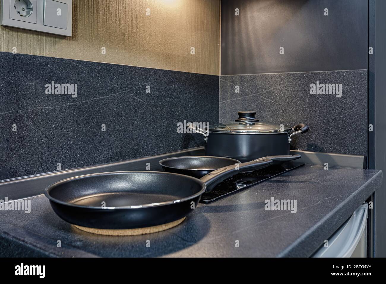 empty pan on stove with stands on table closeup modern kitchenware Stock Photo