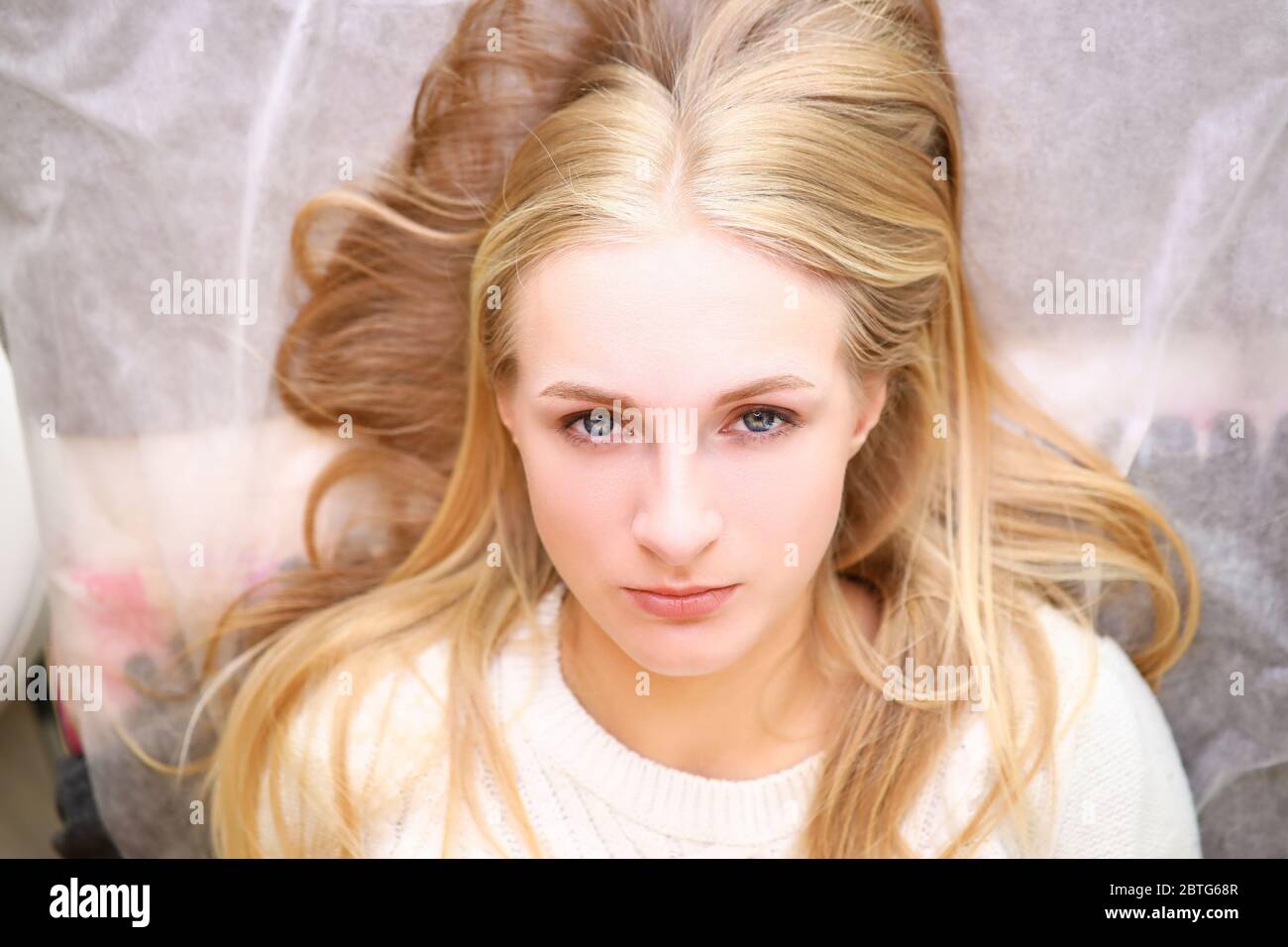 Good-looking lady in white sweater Stock Photo
