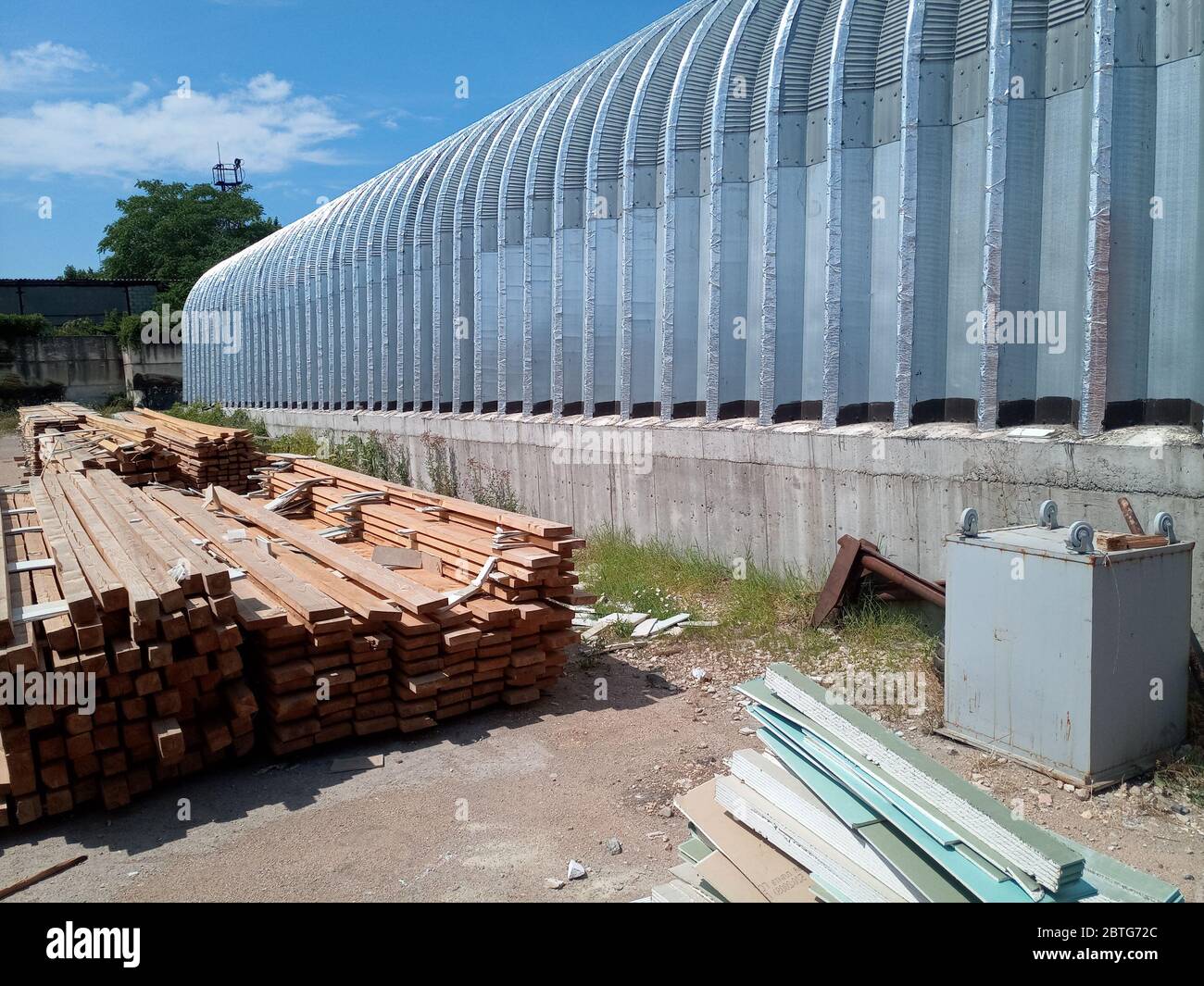 Warehouse of building materials. a Building base, metal, wood and blocks with bricks. Stock Photo