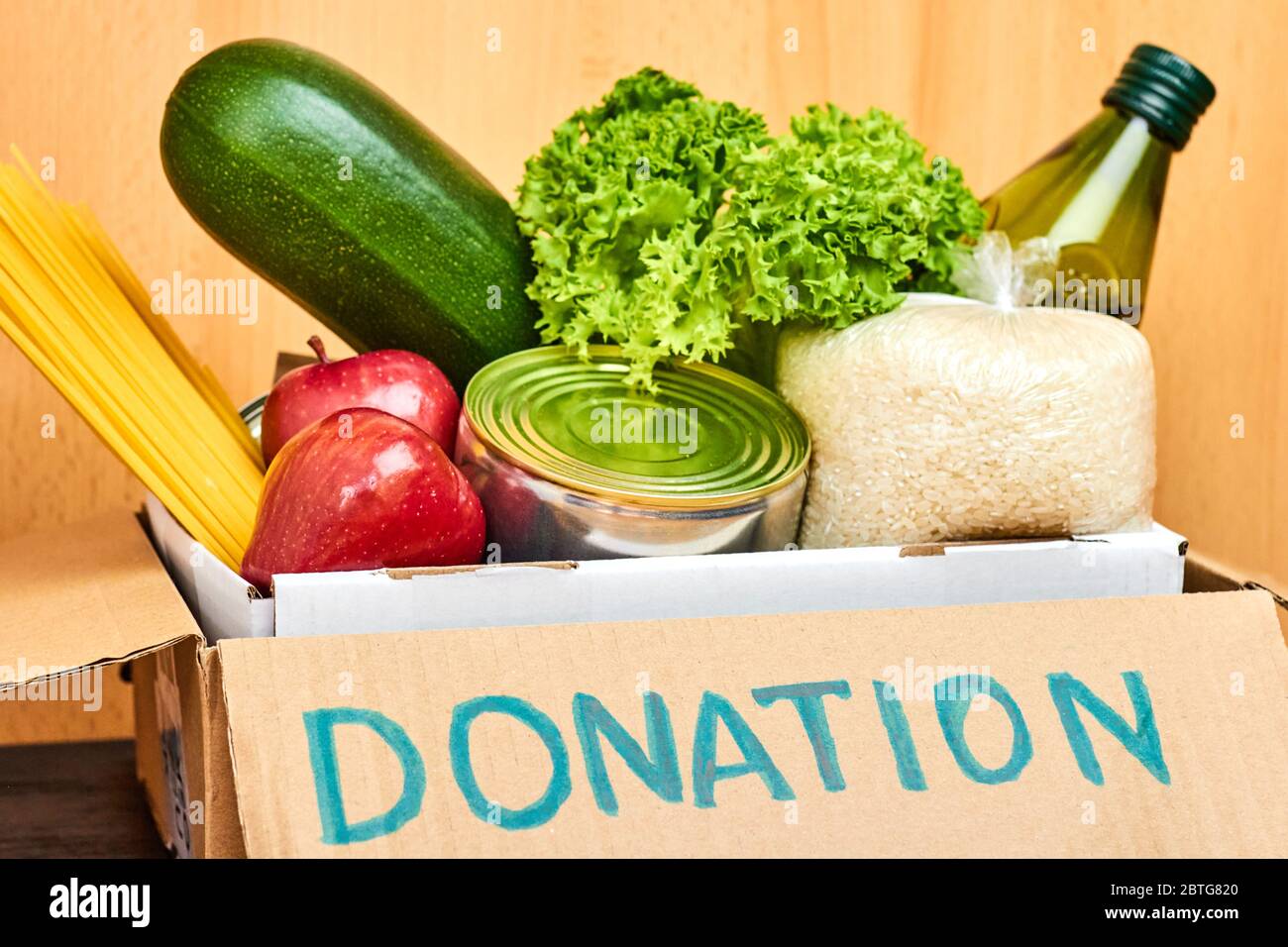 Donation cardboard box with various food, vegetables, fruits, cereals