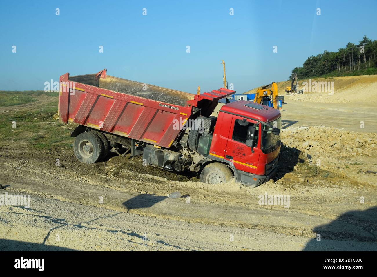 Taman, Russia - June 9, 2019: A dump truck kamaz got stuck in the mud on the side of the road. Stock Photo