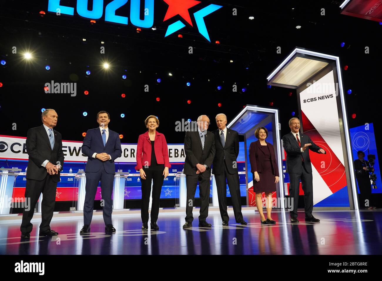 The seven Democratic candidates walk on stage at the start of the CBS News Democratic Debate at the Gaillard Center February 25 2020 in Charleston, South Carolina.  Standing from left to right are: Michael Bloomberg, Pete Buttigieg, Elizabeth Warren, Bernie Sanders, Joe Biden, Amy Klobuchar, and Tom Steyer. Stock Photo