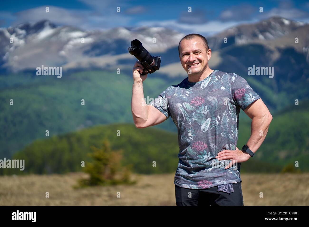 Tourist with camera hiking on a mountain trail Stock Photo - Alamy